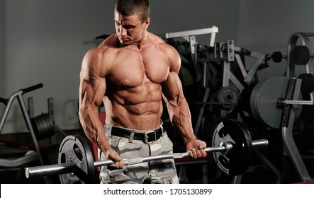 Bodybuilder Exercise With Weights at the Gym, Performing Barbell Curls