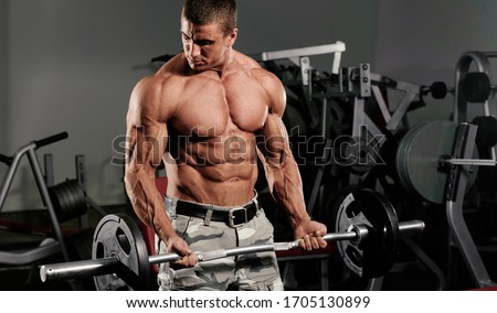 Bodybuilder Exercise With Weights at the Gym, Performing Barbell Curls