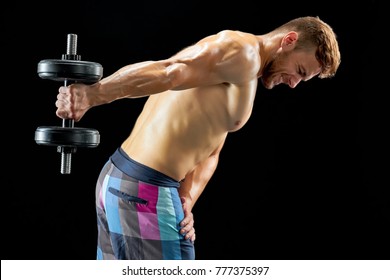 Bodybuilder Lifting Dumbbells And Doing One More Rep Through The Pain. Building Body Of Dream Despite Soreness.