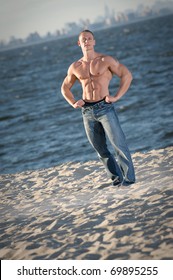 Bodybuilder on Beach posing showing abs