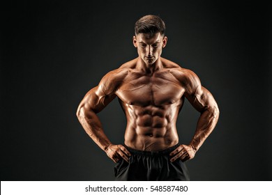 Bodybuilder Posing. Beautiful Sporty Guy Male Power. Fitness Muscled Man