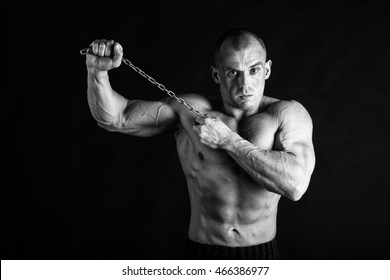 Bodybuilder posing in different poses demonstrating their muscles. Failure on a dark background. Male showing muscles straining. Beautiful muscular body athlete. - Shutterstock ID 466386977