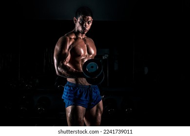 Bodybuilder posing on black background. Muscular and athletic young man doing bodybuilding posing. Gym motivation. Bodybuilder man.