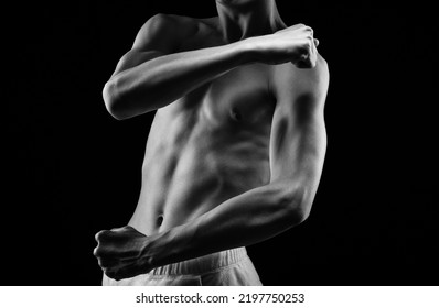 Bodybuilder Shows His Muscles On The Body. He Concept Of Proper Nutrition And Healthy Lifestyle. Photo Black And White