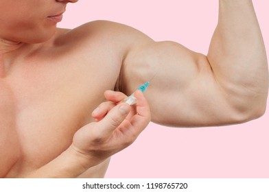 Bodybuilder Taking Steroids Injection In Arm On Pink Background. 