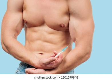 Bodybuilder Taking Steroids Injection In Arm On Blue Background. 
