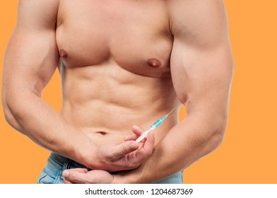Bodybuilder Taking Steroids Injection In Arm On Yellow Background. 