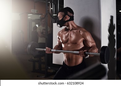 Bodybuilder In Training Mask Working With Barbell