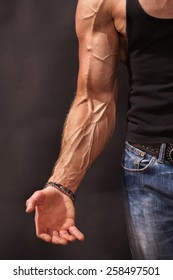 Bodybuilders Hand And Arm With Veins Protruding From Under The Thin Skin 