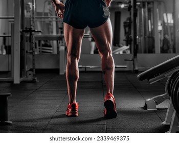 Bodybuilders muscular calf legs. Athlete man doing workout exercise in gym - Powered by Shutterstock