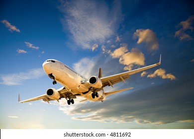 Boeing 737 Commercial Plane Flying Through Dramatic Twilight Sky.