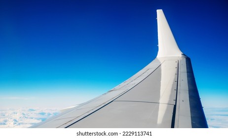 Boeing 737 MAX 8 White Wing Over White Air Clouds And Clear Blue Sky. High quality photo