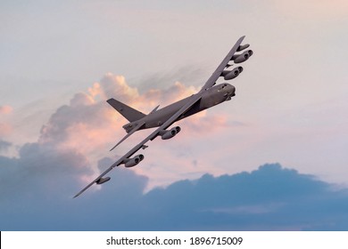 Boeing B52 Bomber of the United `states Airforce (USAF) at sunset. B-52 nuclear and heavy bomber banking towards the camera at sunset. New engine contract from Rolls Royce - Powered by Shutterstock