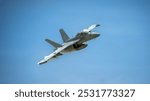 Boeing F-15EX Eagle II fighter jet in flight with beautiful cloudy blue sky background.