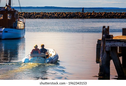 Bogense, Denmark, May 31, 2020
Young Couple Leaving Bogense Harbour, Funen, Denmark, For A Romantic Sunset Sailing Tour.