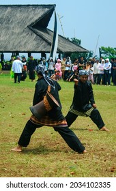 BOGOR, INDONESIA – JANUARY 27, 2008: People Are Watching Two Silat Fighters Demonstrating A Silat Stance During The Seren Taun Event At Sindang Barang.