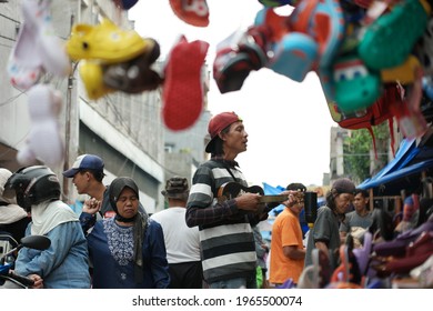 Bogor, Indonesia - July 2017
A Local Artist Singing On The Background Of The Hanging Kids Rubber Shoes