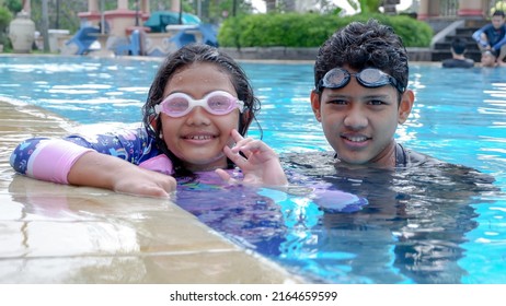 Bogor, Indonesia - May 22nd 2022: Happy Facial Expressions When Children Are Invited To Swim By Their Parents