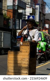 BOGOR, INDONESIA - May 26, 2021: A Vertical Shot Of A Street Performer Singing On A Hot Sunny Day