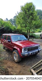 Bogor, Indonesia On Nov 02, 2021: Defocused. Jeep Cherokee Red Color Park In Front Of House Yard. Selective Focus