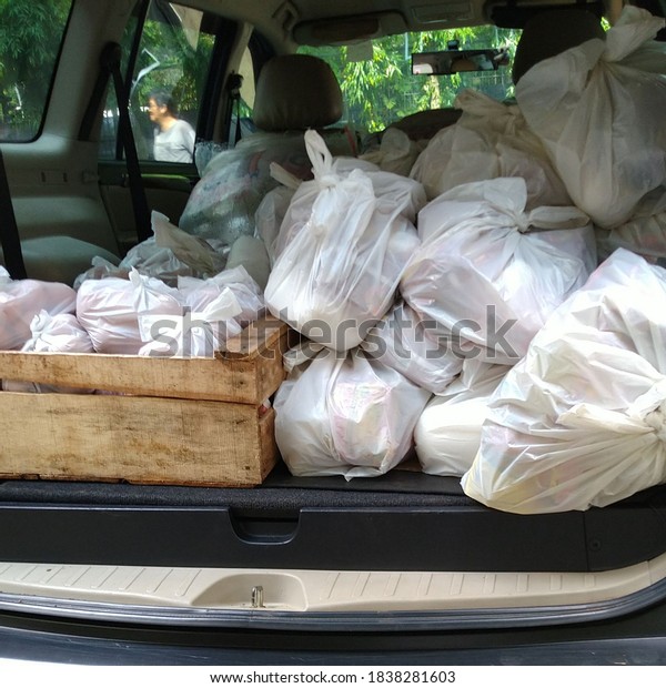 Bogor, West java / Indonesia - July 17 2020: The\
trunk of a car full of basic necessities to be distributed at\
social services