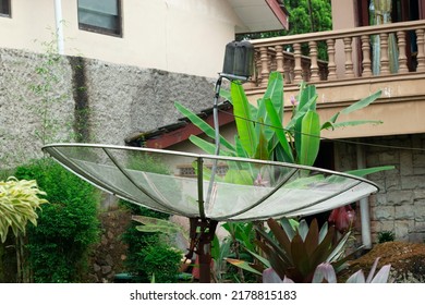 Bogor, west java Indonesia-July 16, 2022 : silver satellite dish is installed in people's homes to receive television broadcasts