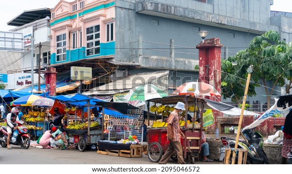 Bogor, West Java - November 12, 2021 : Market\
conditions and street vendors around Pasar Anyar who trade on the\
sidewalk