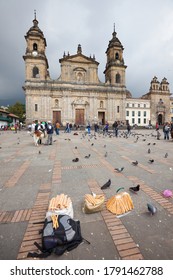 Bogota, La Candelaria, Colombia - Plaza De Bolivar And Cathedral At The Main Square In Downtown With Corn Products Of A Street Vendor.