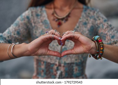 Bohemian Chic Gypsy Woman Wearing Hands Jewelry Accessories And Dress Showing Love Sign. Boho Detail Close Up  