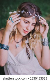 Bohemian Hippie Girl In White Dress.
Woman Hands With Lot Of Boho Style Jewelry, Blue Rings,silver Bracelets And Henna Tattoo.  Coachella Fashion Style Look, Outfit.