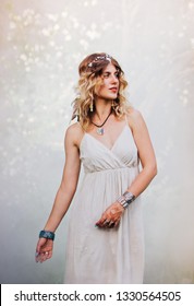 Bohemian Hippie Girl In White Dress Dancing In The Forest.
Woman With Boho Style Jewelry. Colored Smoke On Background.Coachella Fashion Style Look, Outfit.