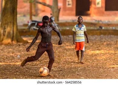 BOHICON, BENIN - JAN 11, 2017: Unidentified Beninese Children Play Football With Bare Feet. Soccer Is Very Popular Game Among The  African Kids