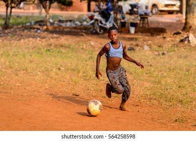 BOHICON, BENIN - JAN 11, 2017: Unidentified Beninese Little Boy Plays Football With Bare Feet. Soccer Is Very Popular Game Among The  African Kids