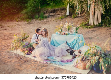 Boho Chic Couple In Love The Bride And Groom. Wedding Inspiration Picnic Outdoors, With The Dinner Table And Decor In Turquoise Colors.