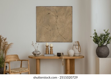 A boho console table adorned with earthy-toned decor pieces, including candles and a ceramic vase. The abstract mock up wall art adds a touch of sophistication to this elegant space.