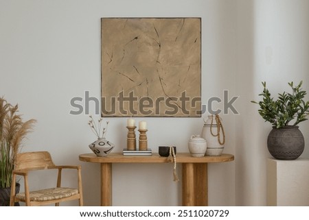 A boho console table adorned with earthy-toned decor pieces, including candles and a ceramic vase. The abstract mock up wall art adds a touch of sophistication to this elegant space.