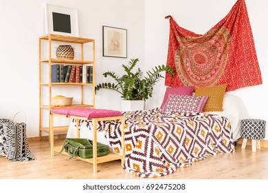 Boho and cozy bedroom in warm oriental colors