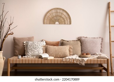 Boho And Cozy Interior Of Meditation Room With Beige Chaise Lounge, Pillows, Ladder, Rattan  Decoration, Books And Personal Accessories. Warm Home Decor. Template.	