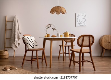 Boho And Cozy Space Of Dinning Room With Round Family Table, Rattan Chairs, Design Pedant Lamp, Commode, Carpet, Decoration And Personal Accessories. Minimalist Home Decor. Template.	
