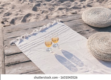 Boho eco styled beach essentials on sand by sea. Romantic picnic for couple on the beach at sunset. - Powered by Shutterstock