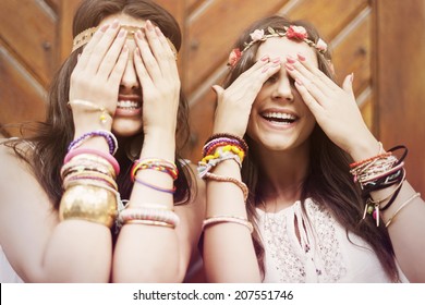 Boho Girls Covering Eyes By Hands 