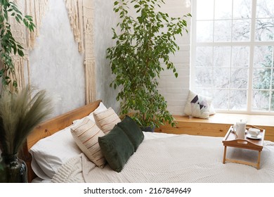 Boho Style Bedroom Interior With Beverage On Bed And Green Plants