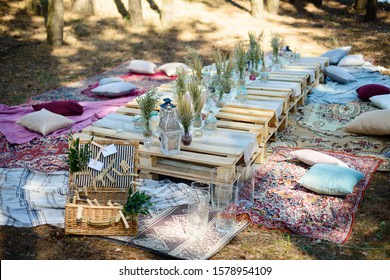 
Boho Style Party Decor In The Forest. Party Decoration For A Bachelorette Party. Furniture From Pallets.