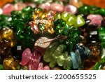 Boho tourmaline and chrome diopside beaded necklace and bracelet with rose gold ring, close up.