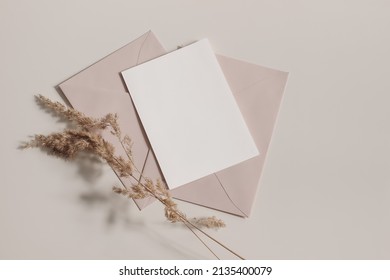 Boho Wedding, Birthday Stationery Composition. Blank Greeting Card, Invitation Mockup, Blush Pink, Nude Envelopes. Dry Grass, Festuca Plant Ins Sunlight On Beige Table Background. Fall Flat Lay, Top 