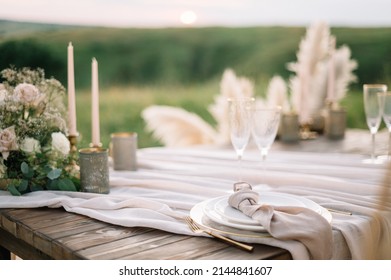 Boho wedding table set. vintage dining table with decorations, flowers and pampas grass  Boho style. Table set for an event, party, date or wedding.