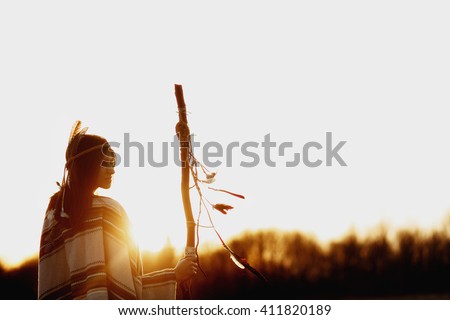 boho woman  shaman with pikestaff on background of sunset beautiful in mountains