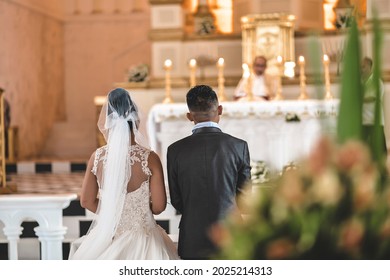 Bohol, Philippines - Jan 2019: A couple face the priest at the altar, at a typical Catholic church wedding in the Philippines.
