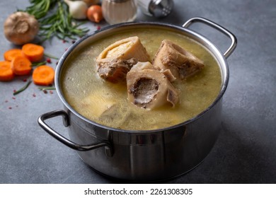 Boiled bone and broth. Homemade beef bone broth is cooked in a pot on. Bones contain collagen, which provides the body with amino acids, which are the building blocks of proteins.