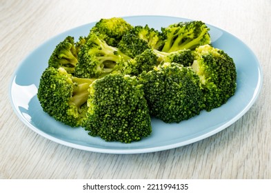 Boiled Broccoli In Blue Glass Plate On Wooden Plate